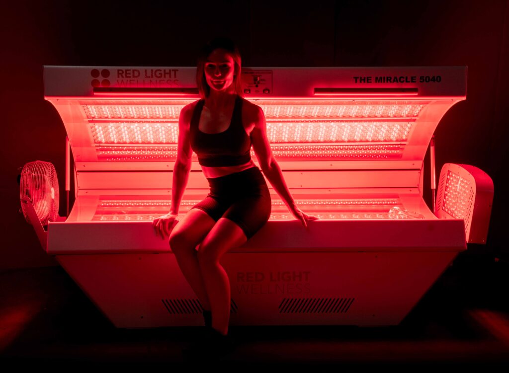 A girl in a medical grade red light therapy bed miracle 9600.