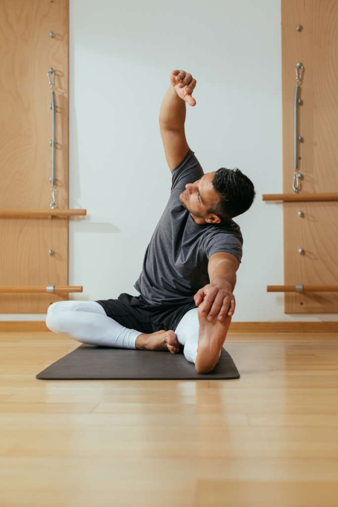 Healthy man doing yoga for wellness and treatment to better his mental health and body.