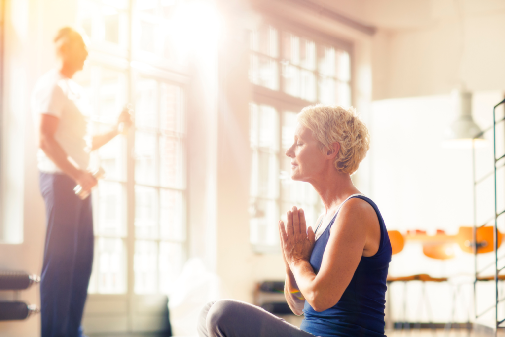 Woman doing yoga and meditation for a healthy lifestyle to reduce her stress and anxiety.